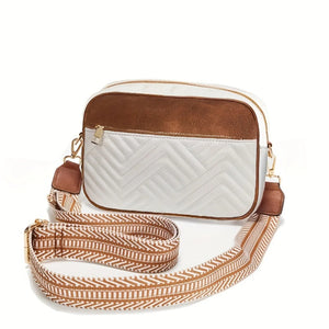 White crossbody bag with brown accents and a patterned strap on a white background